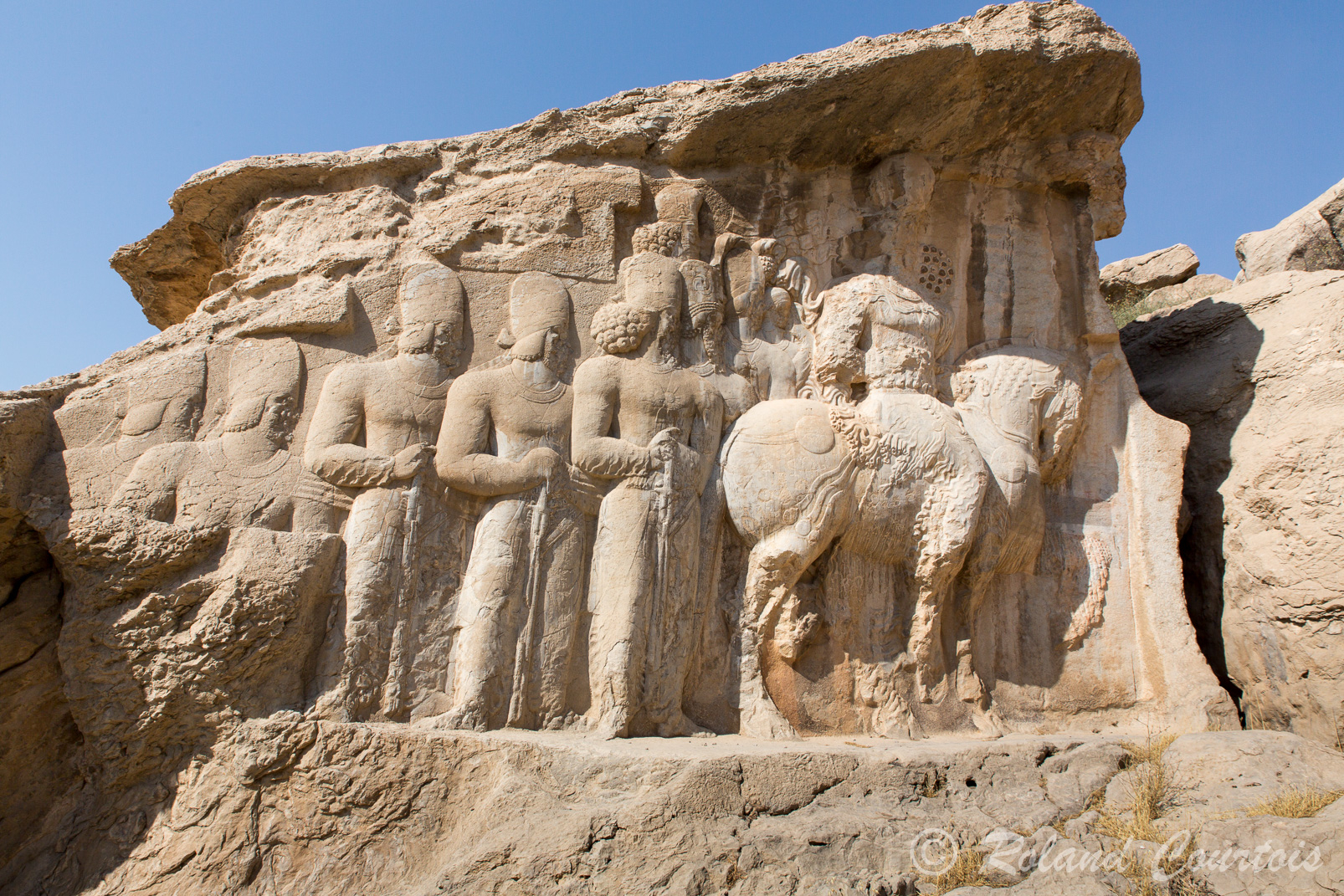 A Naqsh-e Radjab, ce bas-relief représente Shâpur Ier à cheval, suivi d'un groupe de nobles et de soldats.